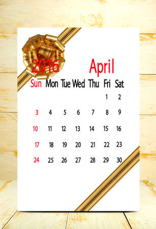calendar for the month of April on wooden boards background closeupの写真素材
