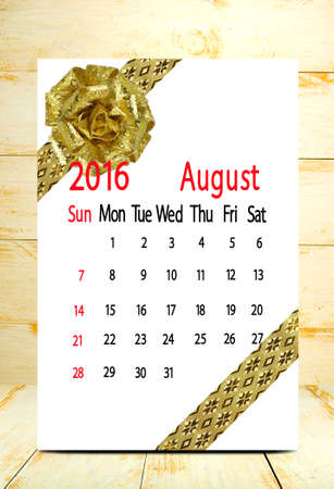 calendar for the month of August on wooden boards background closeupの写真素材