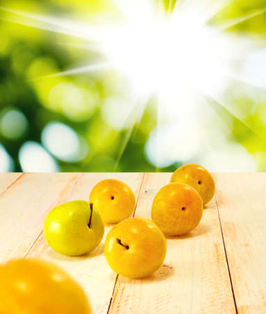image of plums on a wooden tableの写真素材