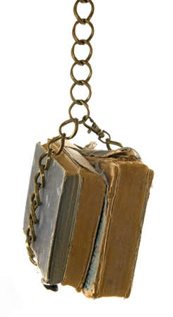 isolated image of old book hanging on the chain close-upの写真素材