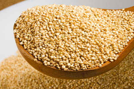 quinoa grains on a wooden board close upの写真素材