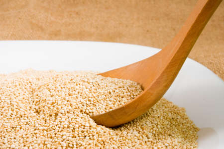 quinoa grains on a wooden board close upの写真素材