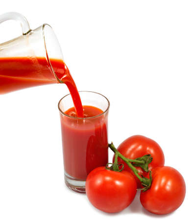 Isolated image of glass of tomato juice and tomatoes close-upの写真素材