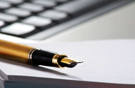 image of pen on keyboard background close up