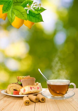 image of cups with tea and cookies on sunlight background close-upの写真素材