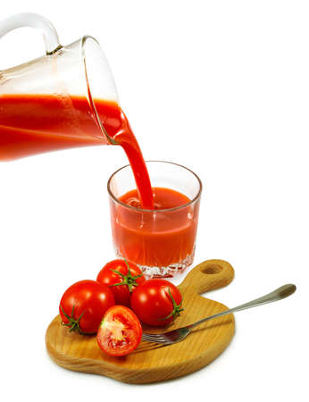 Isolated image of a glass of tomato juice and tomatoes close-upの写真素材