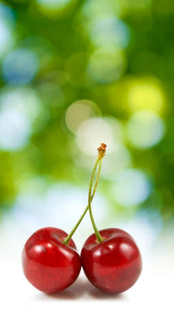 Isolated image of cherries on a green background close upの写真素材