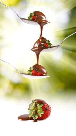 Isolated image of chocolate and strawberry on a spoonの写真素材