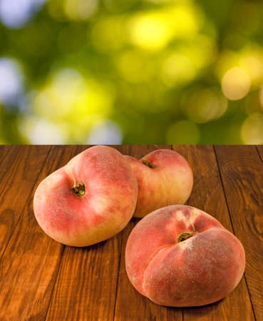 image of peaches on the table on a green background closeupの写真素材