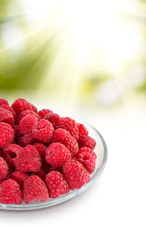 Isolated image of raspberries in a bowl on a white backgroundの写真素材