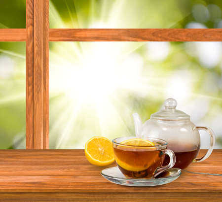 cup of tea on window on green background closeupの写真素材
