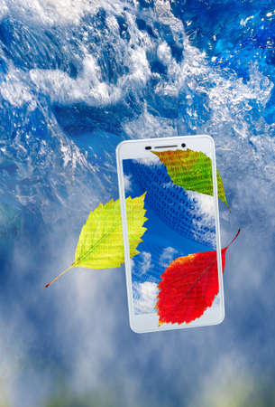 image of smartphone and leaves on water backgroundの写真素材