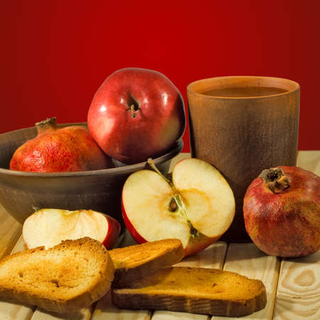apple, pomegranate, crackers on tableの写真素材