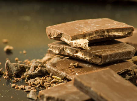 image of dark chocolate.chunks of dark chocolate on a table close-up