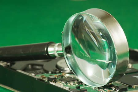 Image of magnifier on microchip backgroundの写真素材