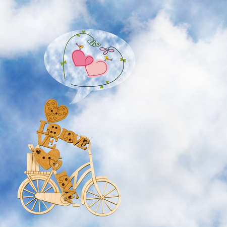 Image of decorative little man on a bicycle against the sky.の写真素材