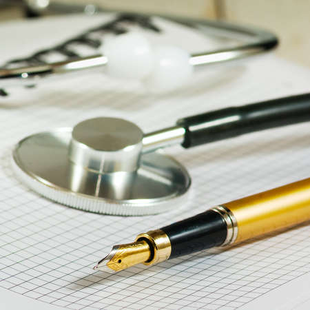 image of stethoscope, notebooks and pen on white backgroundの写真素材