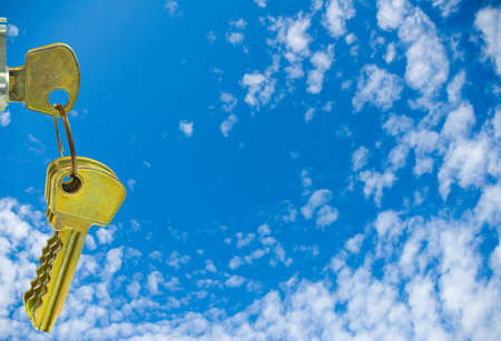 Keys on sky background closeupの写真素材