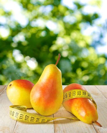 image of pear and a centimeter on a tableの写真素材