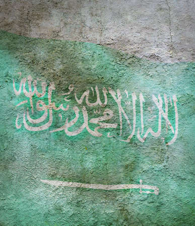 stylized image of flag of Saudi Arabia against the old wall backgroundの写真素材
