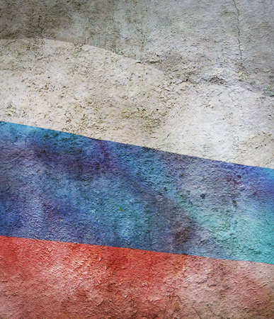 stylized image of flag of Russia against the old wall backgroundの写真素材