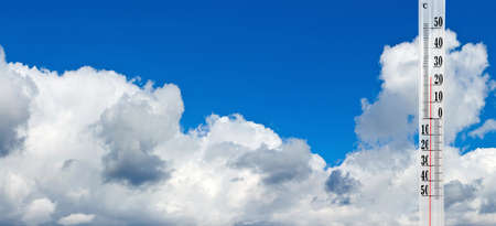 image of thermometer on sky background closeup