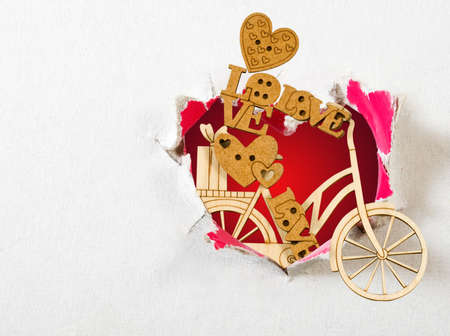 toy wooden bicycle and a stylized heart as a symbol of loveの写真素材