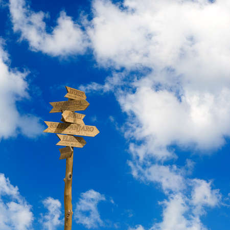 wooden direction signs mountains
 against the skyの写真素材