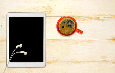 image of a cup of coffee and a tablet close-upの写真素材