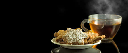 cup with tea and a plate with cookies closeupの写真素材