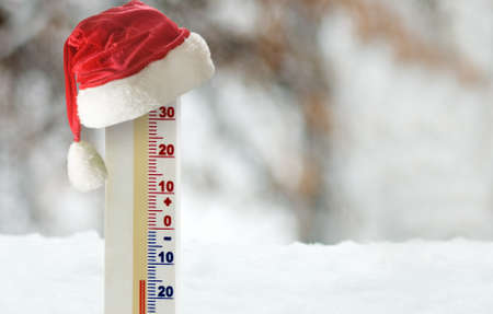 An image of a thermometer inserted into the snow and a stylized Christmas hat