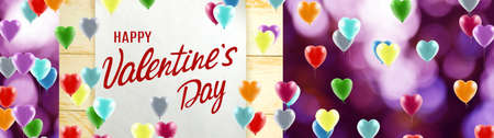 Happy Valentine's Day with colorful balloons depicting stylized hearts.の写真素材