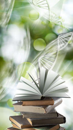 The image of a stack of books and an open book on a stack against the background of stylized DNA chains.の写真素材