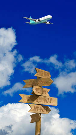 image of a road sign against the background of the sky, clouds and an airplane