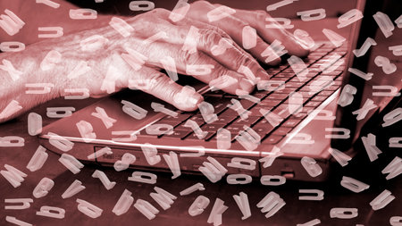 The image of hands on the keyboard keys combined with the image of letters randomly located in spaceの写真素材