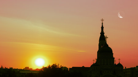 The image of the sunset and against the backdrop of the sunset the building of the churchの写真素材