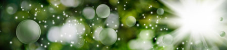 Abstract image of green blurred background with bokeh, bright flash of light and flying balls. Horizontal bannerの写真素材