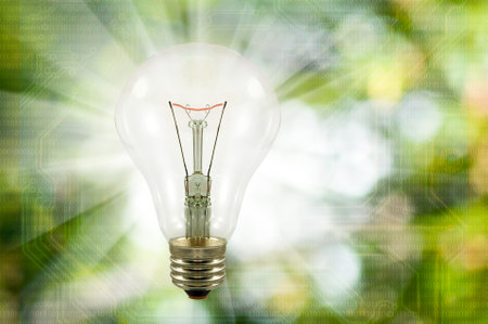 Light bulb image on blurred green background and binary code digitsの写真素材