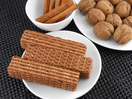 set of cake, walnut and cinnamon on white plateの写真素材