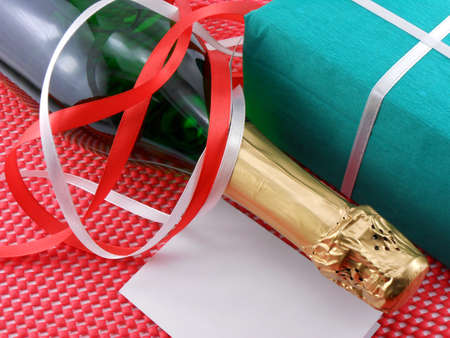 Bottle of a champagne and green gift boxesの写真素材