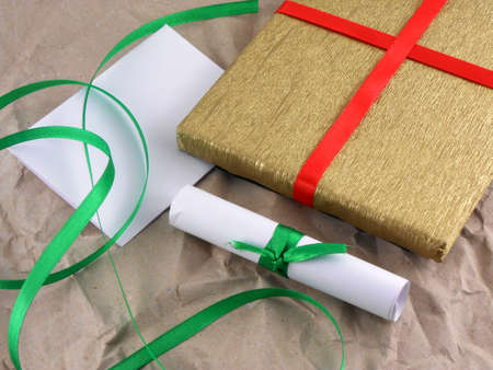 golden gift box with red bow on vintage grunge paper