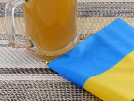 glass of beer with ukraine flagの写真素材