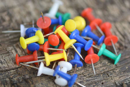 old push pins set on old wooden backgroundの写真素材