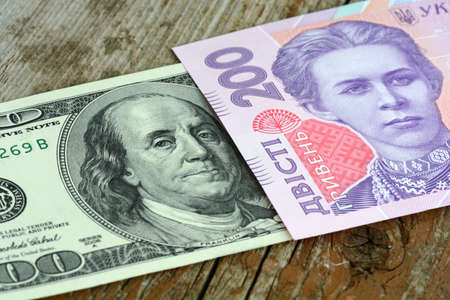 dollars euro hryvnia banknotes on wooden background