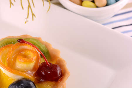 Chocolate cake with cherry and olive on white plateの写真素材