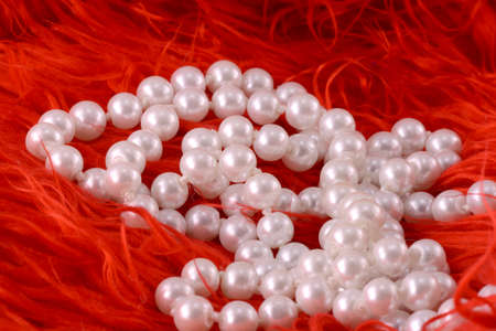 Pearl necklace on luxury red fir backgroundの写真素材
