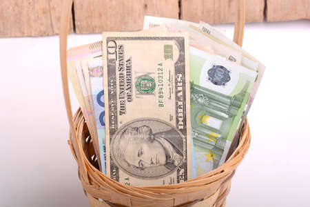 money set in a basket, dollars, euro and ukrainian moneyの写真素材