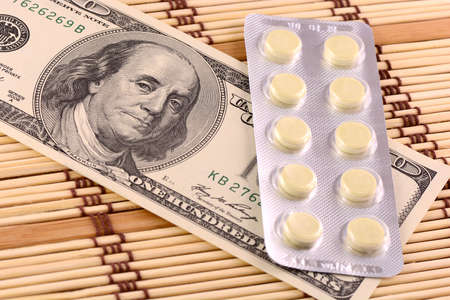 Pills and american money close-up background