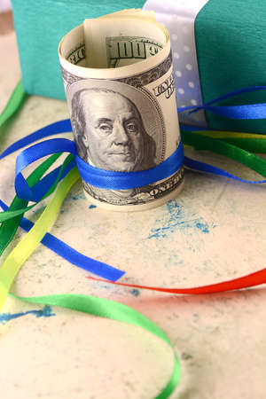 american money dollars and green gift box
