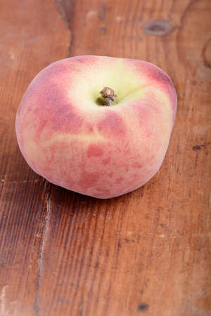 Peach on wooden plateの写真素材